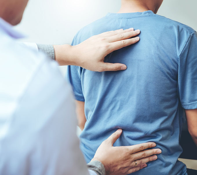 Doctor inspecting patient's back